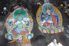 Thame 06 Paintings Of Green Tara and Padmasambhava On Rock Wall Next To Entrance Bridge To Thame